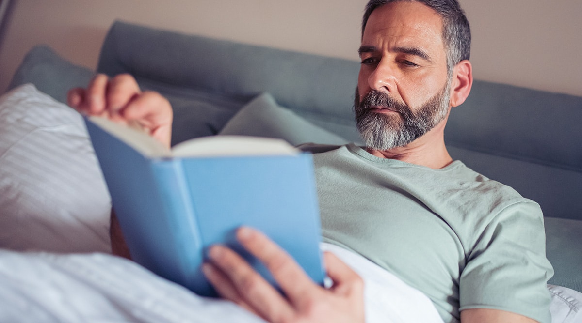 man reading in bed