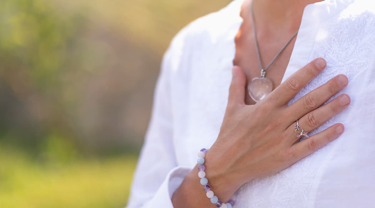 woman holding hand over heart