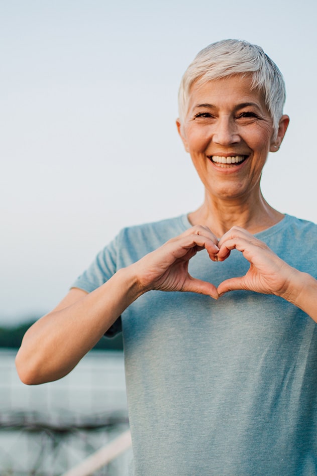 woman making heart symbol with her hands